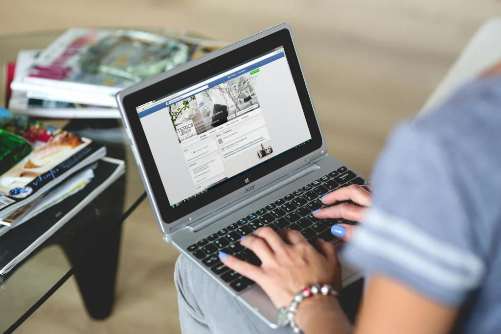 A person using facebook on laptop