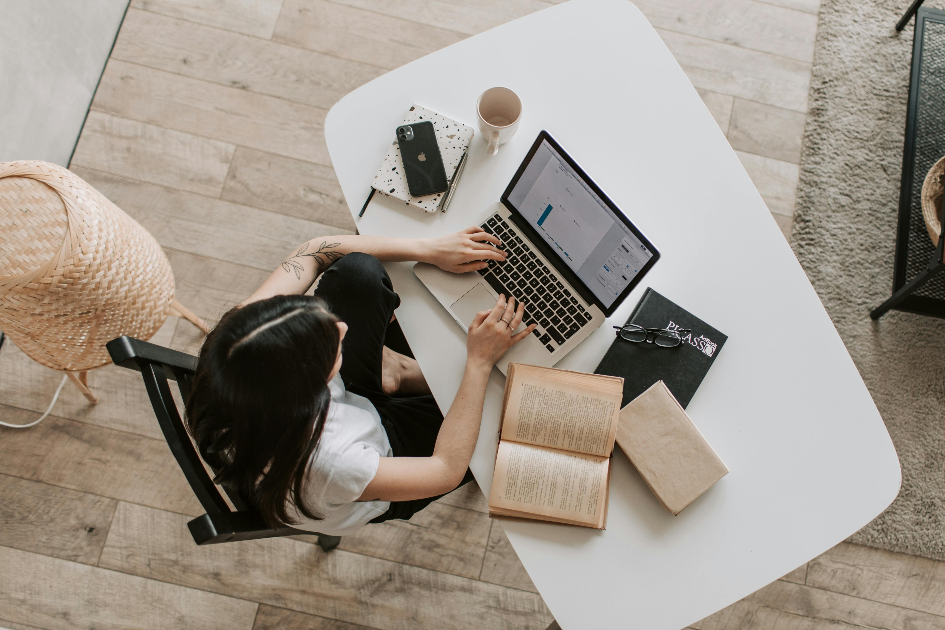 A women sitting in a chair working on laptop