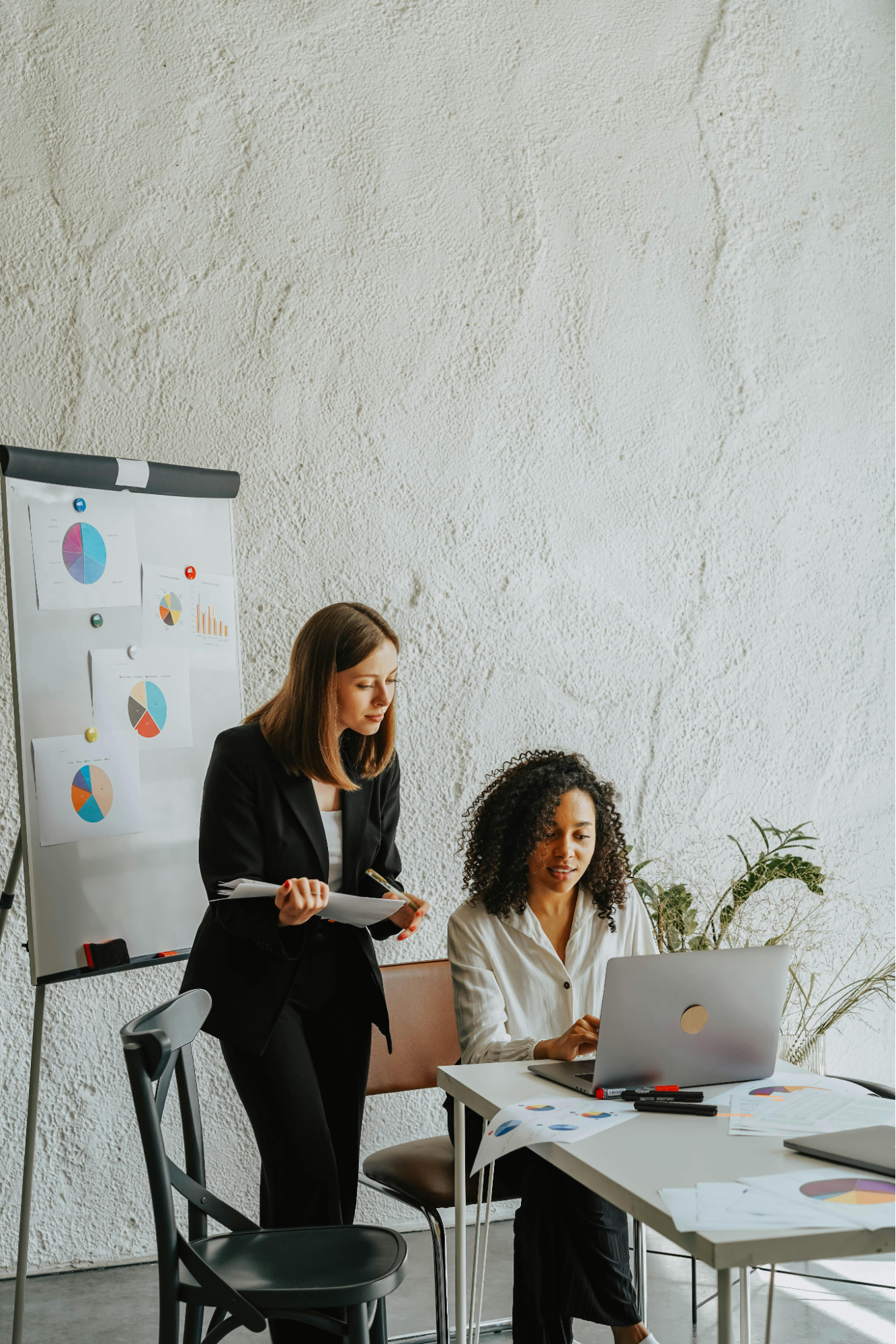 Two women discussing work in the office