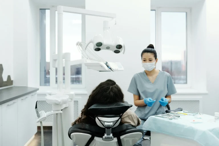 A female doctor looking at a patient lying on a chair