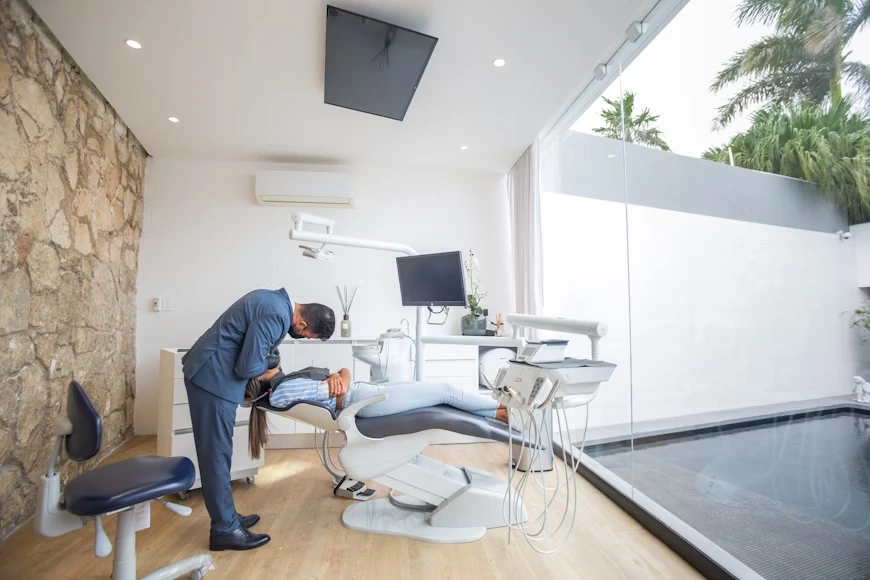 A dentist examines a patient in a dental office