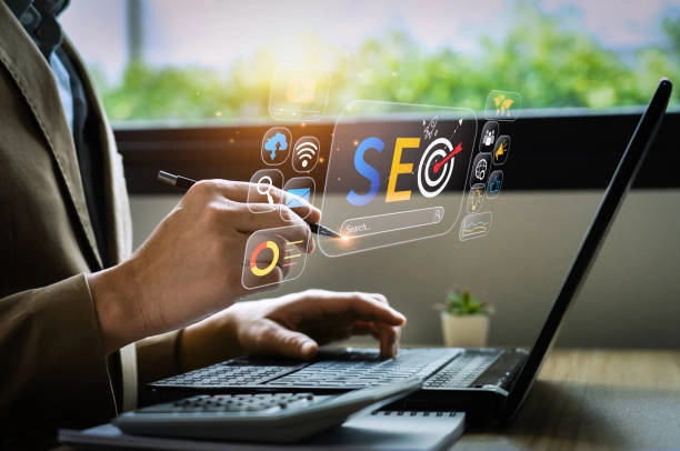 Person using a laptop with SEO graphics overlay