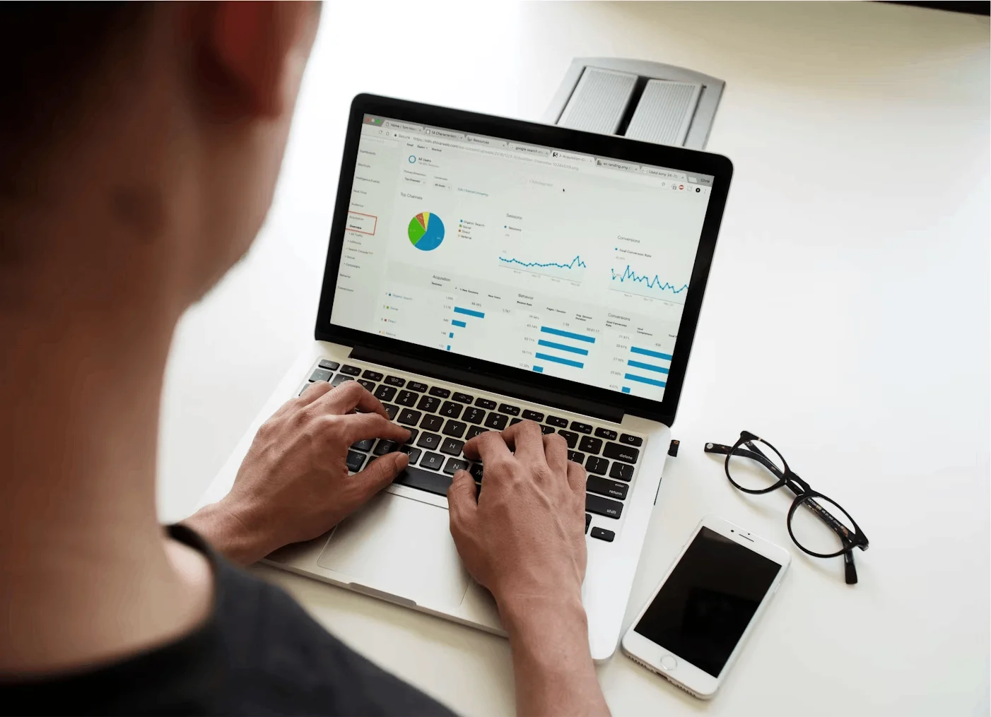 Person analyzing website analytics dashboard on laptop