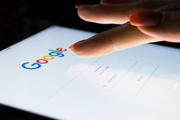 A woman's hand is touching screen on tablet